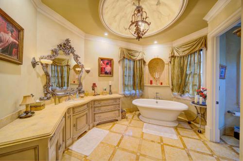 a large bathroom with a tub and a sink and a mirror at 9-Bedroom Atlanta Mansion for Rentals and Events in Marietta