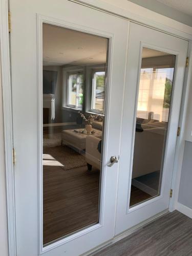 a door with a mirror in a room at Spacious Drumheller-RetreatMuseum & Golf in Drumheller