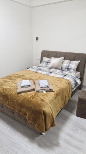 a large bed with two towels on top of it at Air-Moldova N1 in Chişinău
