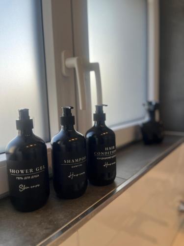 a group of four bottles sitting on a bathroom counter at Apartment Weitblick in Wuppertal
