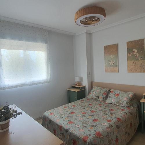 a bedroom with a bed and a window at Casa Dorada Primera Línea Oropesa in El Borseral