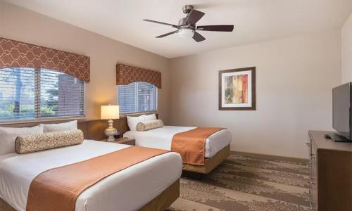 a hotel room with two beds and a ceiling fan at Beautiful Hotel in Nashville 2BD in Nashville