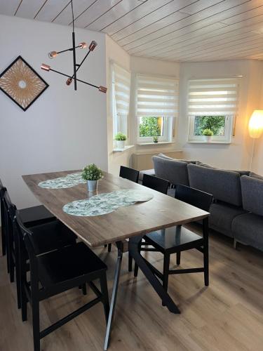 a dining room and living room with a table and chairs at Casa Blanca 1 in Schwanau