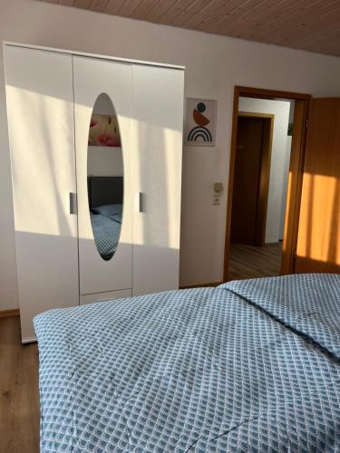 a bedroom with a bed and a mirror on the wall at Casa Blanca 1 in Schwanau