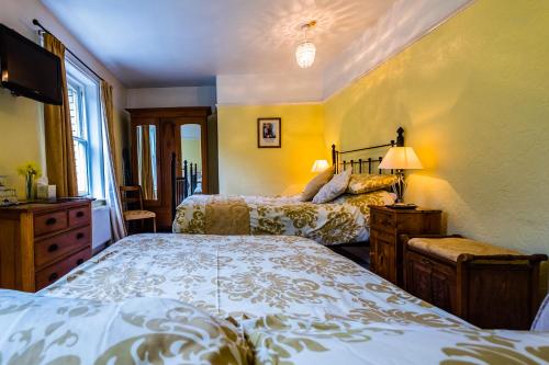 a bedroom with two beds and a window at Broomfield House in Whitby