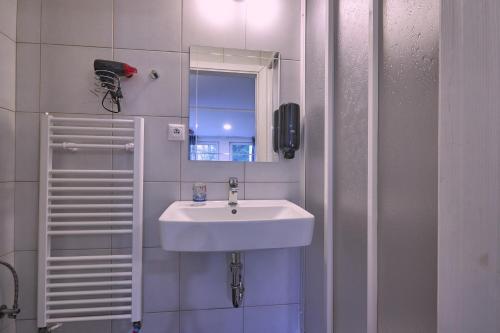 a bathroom with a sink and a mirror at Penzión MALINO in Ružomberok