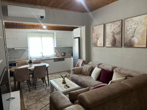 a living room with a couch and a table at Vasil's Apartment in Gjirokastër