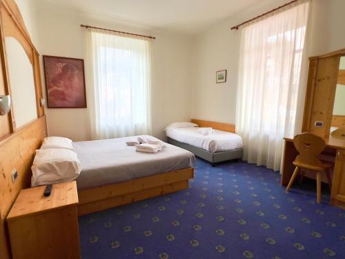 Ένα ή περισσότερα κρεβάτια σε δωμάτιο στο Hotel Regina del Bosco