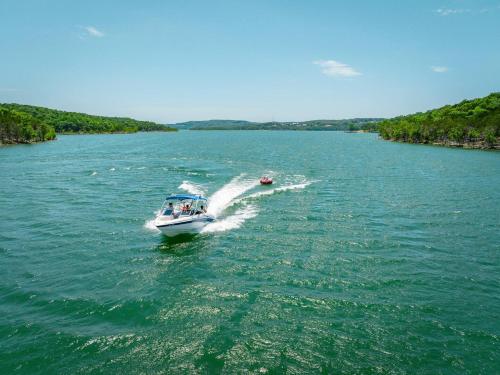 a boat in the water on a river at Steps to Table Rock Lake, Min to Silver Dollar City in Branson