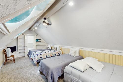 a attic room with three beds and a tv at Maverick Mountaintop Retreat in Canyon Lake