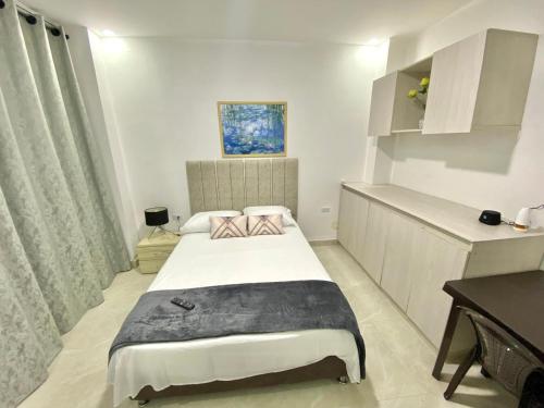a small room with a bed in a room at Perla del río habitaciones in Barranquilla
