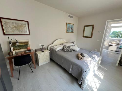 a bedroom with a bed and a table and a desk at Desenzano Lakeview - Luxury Flat in Desenzano del Garda