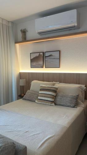 a bedroom with a large bed with two pillows at Skylux 906 - Studio in Rio de Janeiro