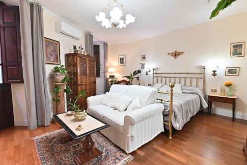 a living room with a bed and a couch at casa vacanze edwige castello in Cagliari