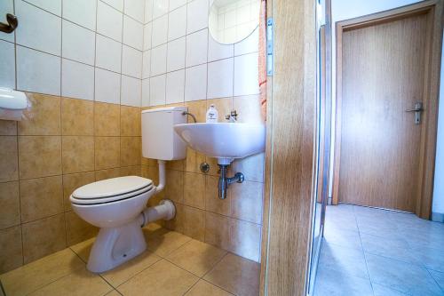 a bathroom with a toilet and a sink at Split Apartments Shell in Split