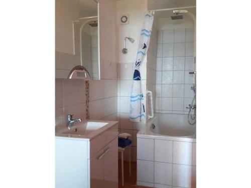 a bathroom with a sink and a tub and a shower at 3 with Atelier-Schleiblick in Maasholm