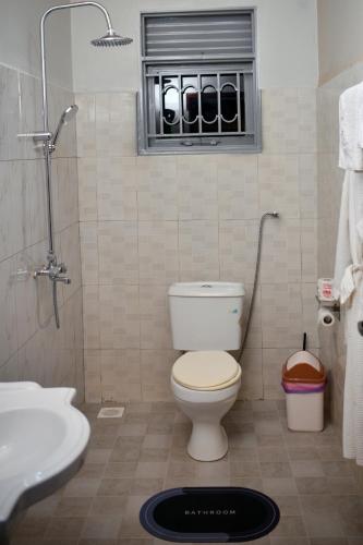a bathroom with a toilet and a sink at Doreens Villa in Wakiso