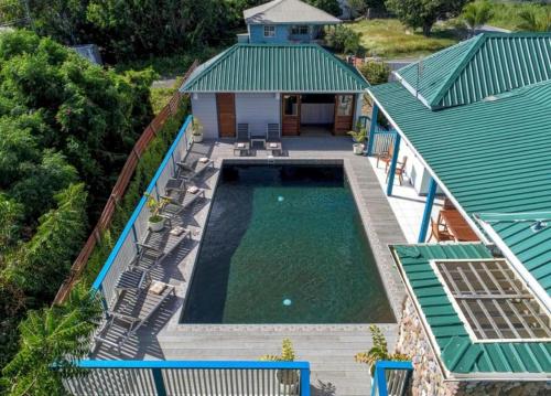 an overhead view of a swimming pool next to a house at Titi Vacation Homes in Cobbs Cross
