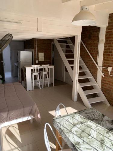 a room with a staircase and a table and a kitchen at Depto Amonite Mar Caribe in Puerto Madryn