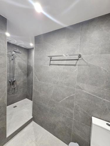 a bathroom with a shower and a toilet at Makenzy Mermaid 2 Bedroom Apartment in Larnaca