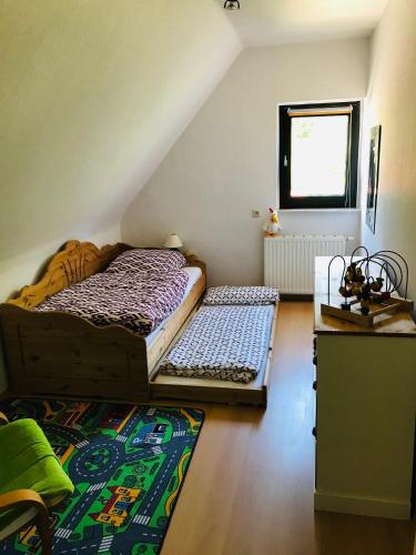 a attic room with two beds and a rug at Ferienhaus Thalblick in Ruhla in Ruhla