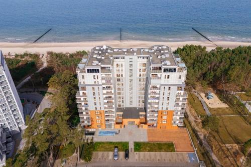 an aerial view of a building next to the beach at Sunset Waves - Right at the beach in Dziwnówek