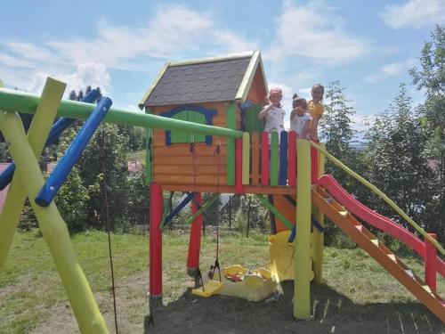 a group of children playing on a playground at Nad Potokiem in Kluszkowce