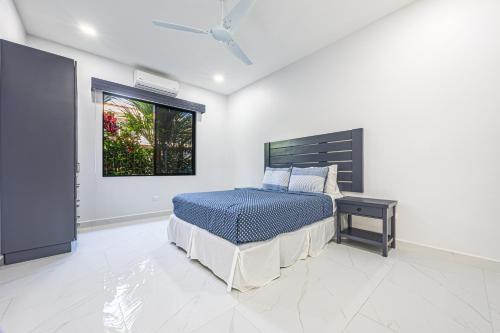 a bedroom with a bed and a window at CASA SERENITY , brand new house, walk 2 beach, private pool, wifi, PURA VIDA!!!! in Uvita