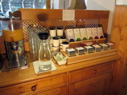 a counter with a coffee maker and books on it at Hotel Alpensonne in Riezlern