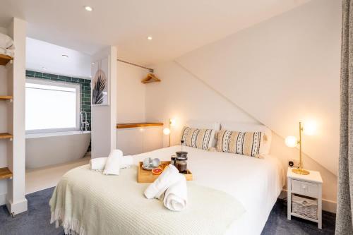 a bedroom with a bed with towels on it at Magnificent Beach House in Caister-on-Sea
