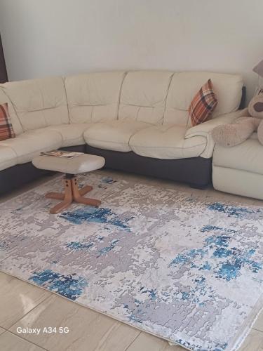 a living room with a couch and a rug at Luxe lagoon guest house in Kasongha