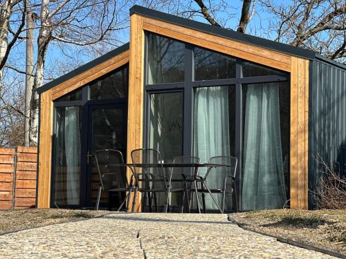 a screened in porch with chairs in a house at Tiny House Útulno in Trojanovice