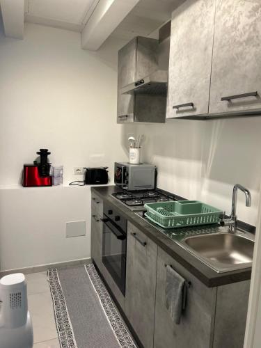 a kitchen with a sink and a stove top oven at B&B Il Sogno in Lamezia Terme