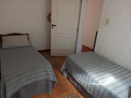 a bedroom with a bed and a door to a room at La Casita Junin in Junín