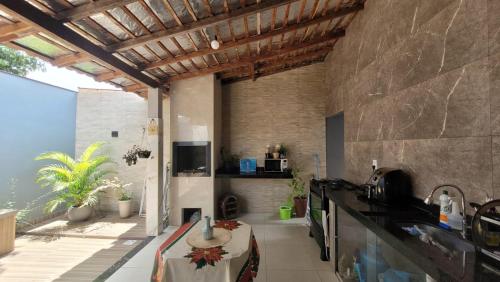 a kitchen with a table and a counter top at Casa 3 Quartos in Ananindeua