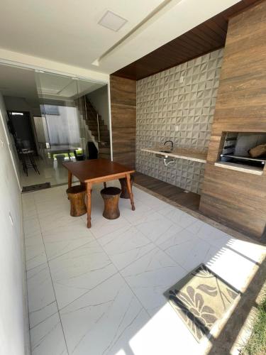 a room with a wooden table and a counter at Barra de Jacuipe beach house in Barra de Jacuípe