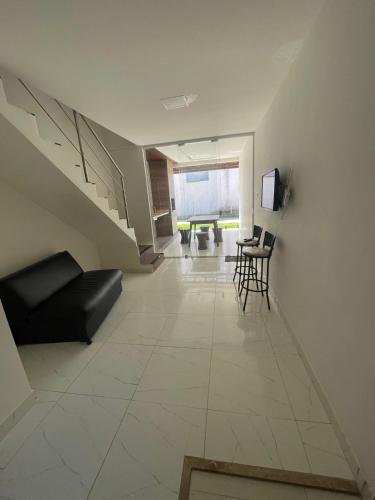 a living room with a couch and a table at Barra de Jacuipe beach house in Barra de Jacuípe