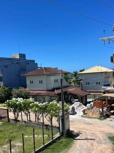 a street with a fence and trees and buildings at Barra de Jacuipe beach house in Barra de Jacuípe