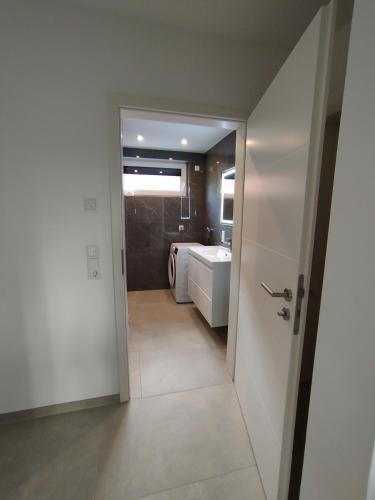 a bathroom with a toilet and a sink and a door at Natur Oase 1 in Goch