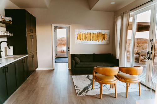 a living room with a green couch and two chairs at Stardust Big Bend Luxury A-Frame#1 with a fab view in Terlingua