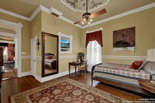 a bedroom with a bed and a mirror at The Abbott House & Event Venue in Seguin