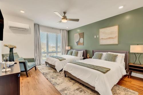 a bedroom with two beds and a ceiling fan at Charming House in Nashville