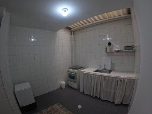 a small kitchen with a sink and a stove at Bacata Housing in Bogotá
