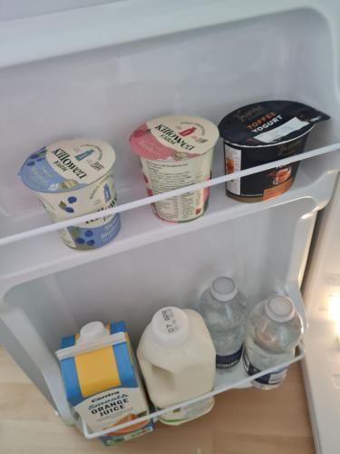a refrigerator filled with lots of food and milk at Aurora in Waterford
