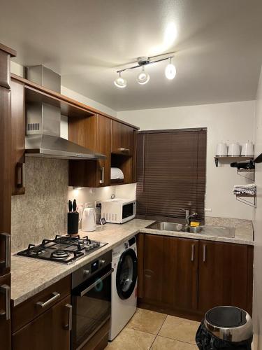 a kitchen with a stove top oven next to a dishwasher at PR 2 BR Modern Home in Middlesbrough