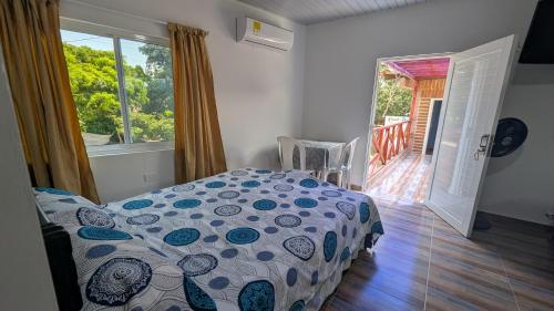 a bedroom with a bed and a window with a porch at Chalet Real in Lemos