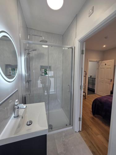 a bathroom with a shower and a sink at Newly Refurbished Townhouse in Derry Londonderry