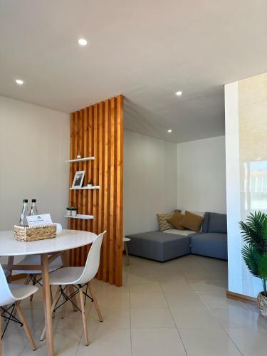 a living room with a table and a couch at Furadise Apartment in Ovar