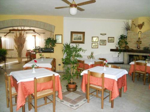 a dining room with two tables and a fireplace at Agriturismo La Selva in Nocera Umbra