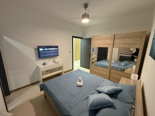 a bedroom with a large bed and a television at Traveller's Rest Gudja in Gudja